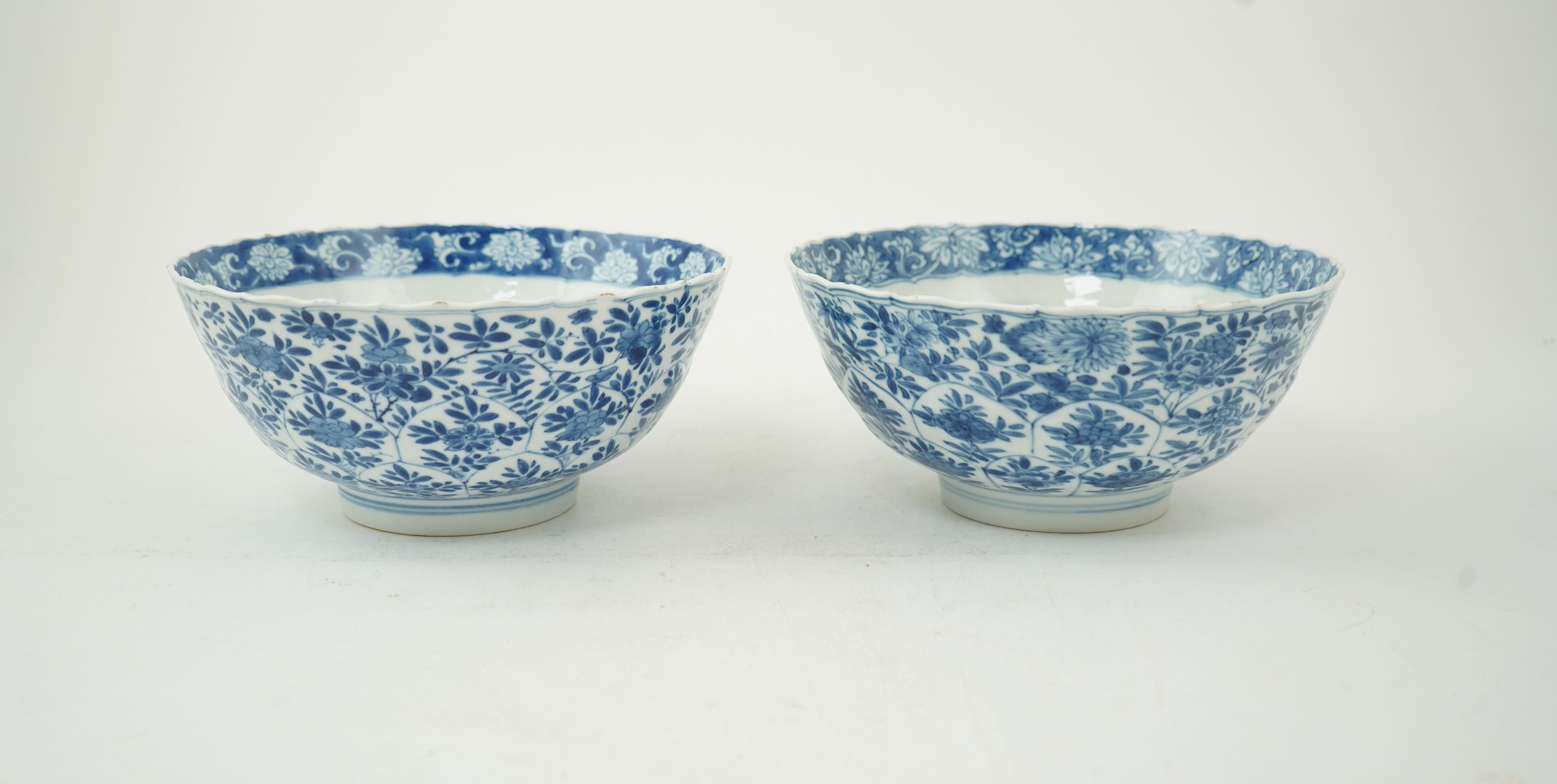 A near pair of Chinese blue and white lotus flower moulded bowls, Kangxi period